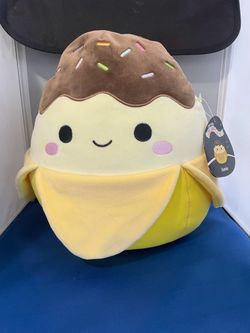 Squishmallows 12-Inch Select Series Junie the Banana plush toy, featuring a cute chocolate-dipped banana design with colorful banana and sprinkles