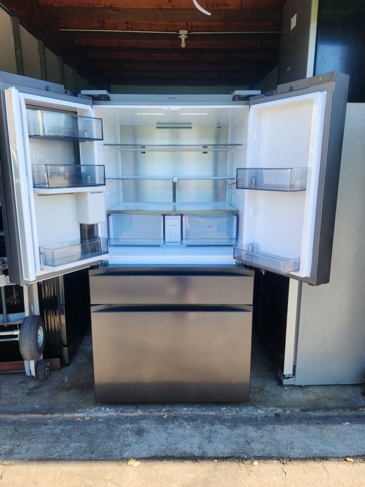 A Samsung 4-door refrigerator has a screen that is 36 inches wide by 68.5 inches high and 29 inches deep.