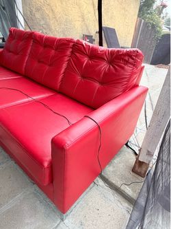 Red three-seater sofa