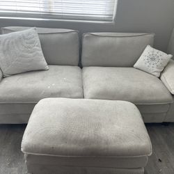 Grey Couch With Automan And Pillows