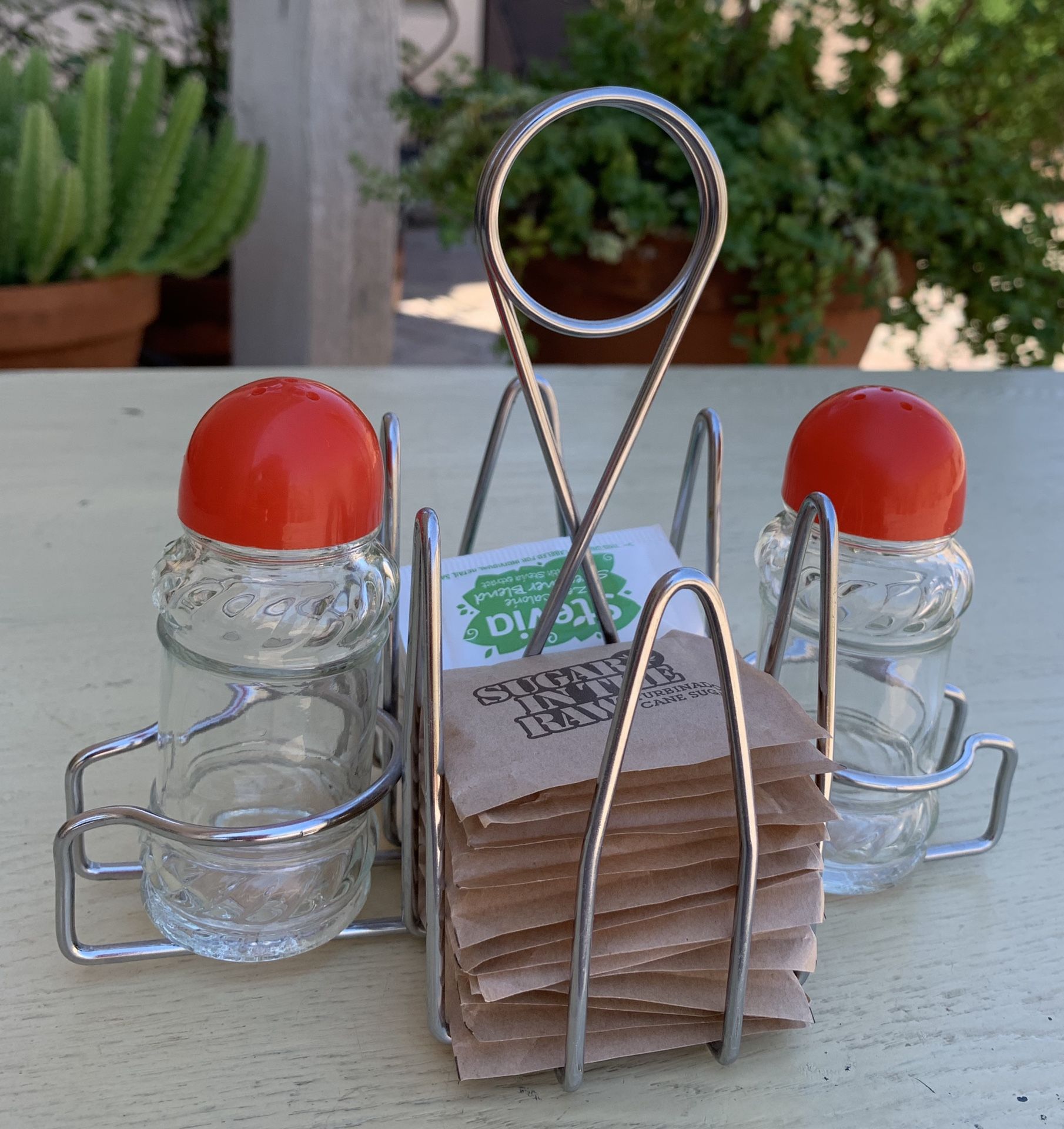 Vintage red lid salt and pepper shakers / sugar packet holder / rack. Cafe/ Diner / Restaurant table top.
