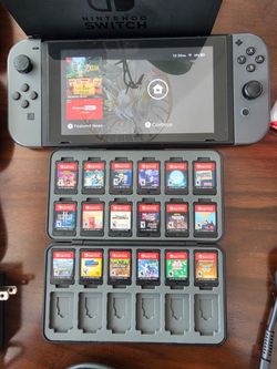 Nintendo Switch with controllers, travel case and 18 Game Cartridges