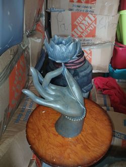 Hand holding flower figuring home decor