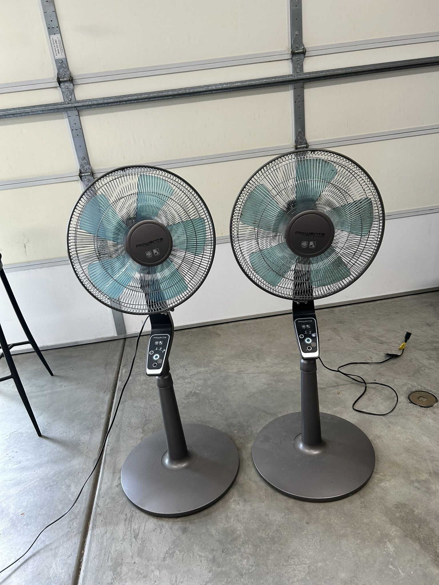 Tall, Blue And Gray Oscillating Fans.
