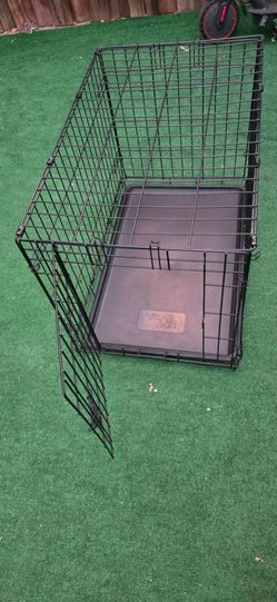 You & Me folding metal wire dog crate (a Petco house brand), identifiable by the logo stamped directly onto the removable plastic tray