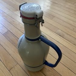 ceramic bottle with some writing on it 