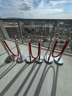 3 sets of velvet ropes and posts red stanchions