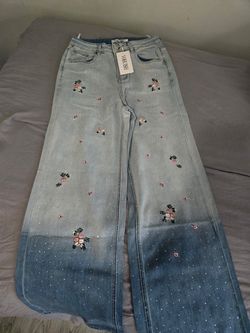 Light wash wide leg floral embroidered rhinestone jeans, high waisted with scattered sparkle detailing
