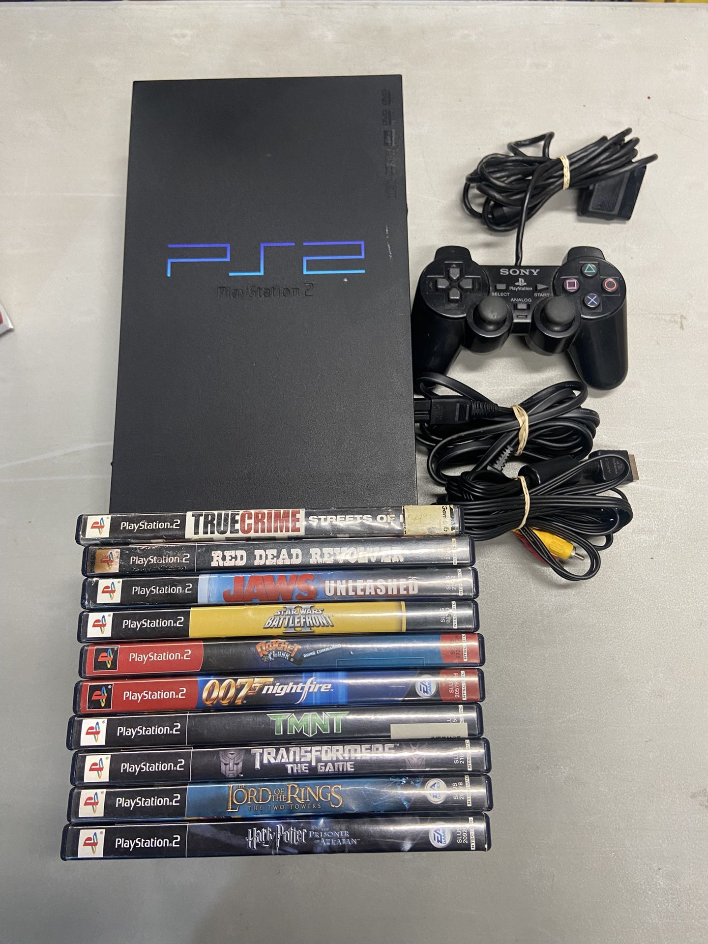 PlayStation 2 Console With 10 Games and 1 Controller For Sale $150 OBO. Tested