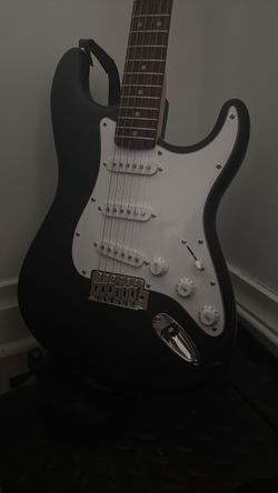Black Stratocaster-Style Electric Guitar and Amp