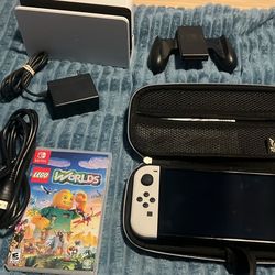 NINTENDO SWITCH OLED WITH DOCKING STATION, LEGO WORLDS, JOYCON GRIP, HDMI AND ZELDA CASE 