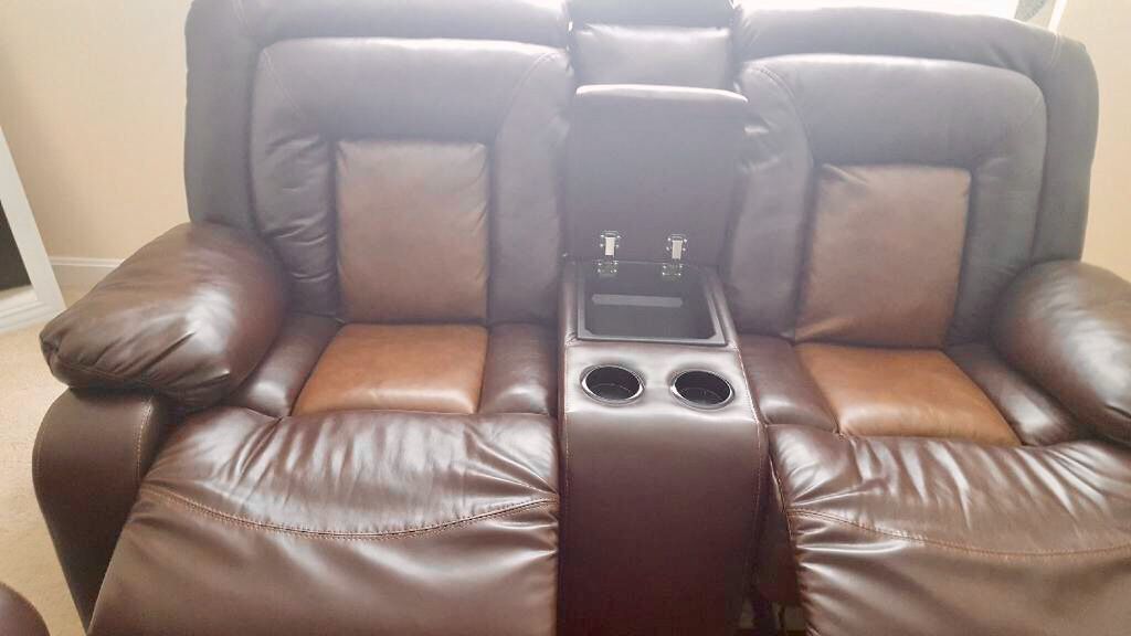 Set of brown leather chairs and recliners