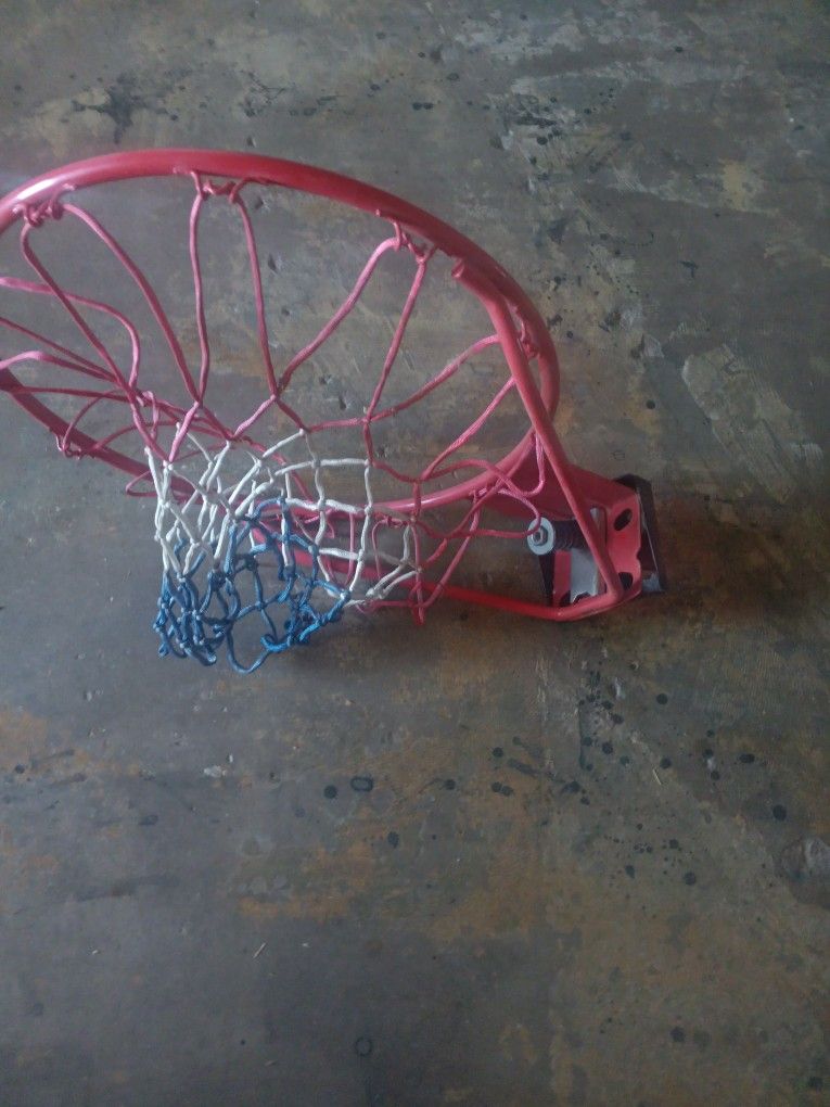 Slightly Used Regulation Sized Basketball Hoop And Net.