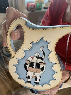 Cow on pitcher. Wood art