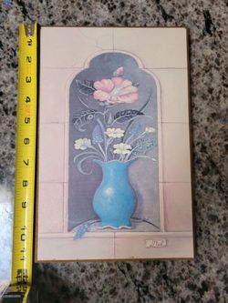 Art plaque featuring a vintage-style floral bouquet in blue vase