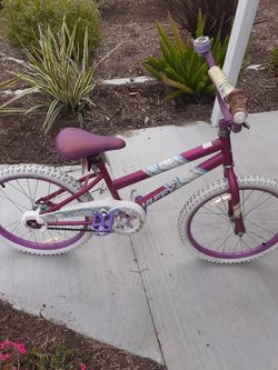 Girl pink and white bike pretty new you can look at the tires just been in the sun backyard of family