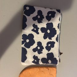 An Orange Flower Patterned Bag And An A White Flower Bag