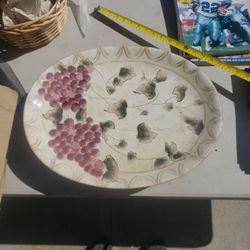 This is an Oneida serving plate made of porcelain or glass 18" wide very good condition no chips or cracks