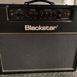 BLACK STAR  AMP WITH RED AND WHITE STRAT GUITAR