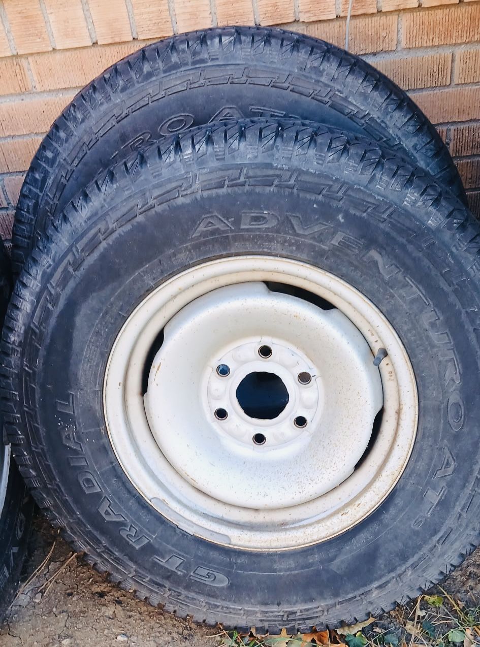 SET OF 4 NEAR NEW TIRES ALL SEASON AND STOCK WHEELS