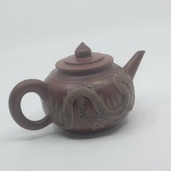 Vintage Chinese Yixing Zisha Pottery Carved Dragon teapot. Perfect 
shape, no chips or cracks - see one of the photos.  It is slighlty lower 
than 4".