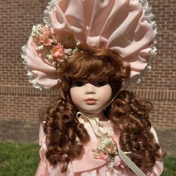 Vintage American Classics Cracker Barrel Collection 23” Porcelain Doll "Wendy"  Measurements are approximate. A rosette is on one shoe only.   Non-smo