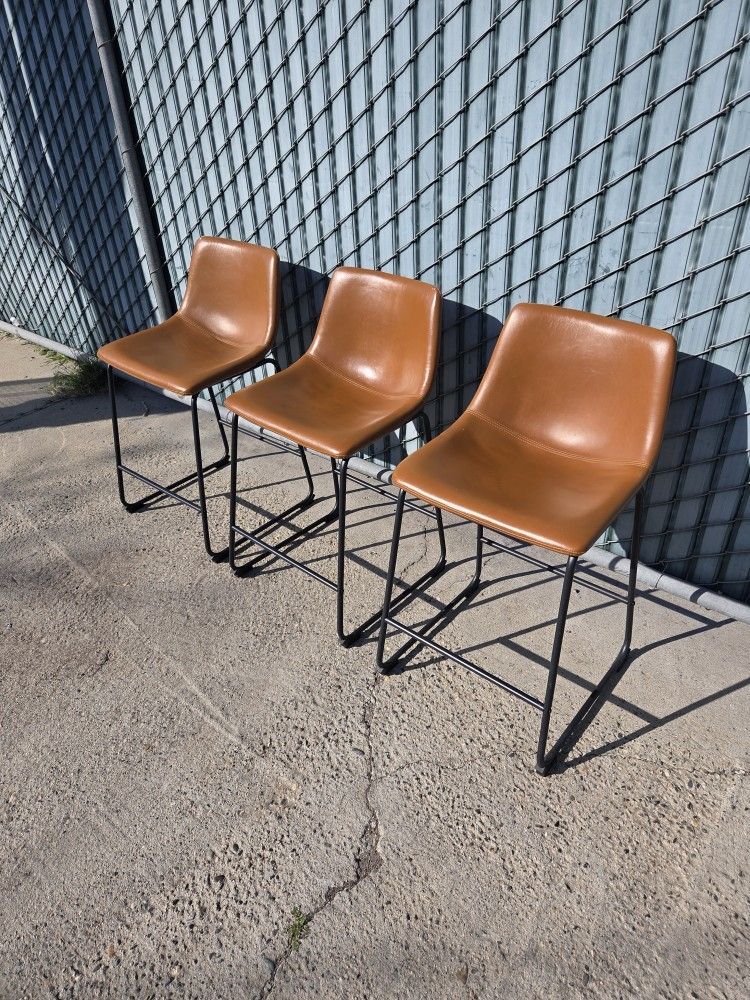 Three leather counter stools 24"