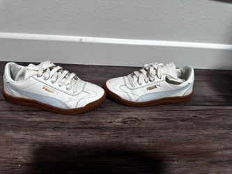 Puma white sneakers with gum soles and light blue accents