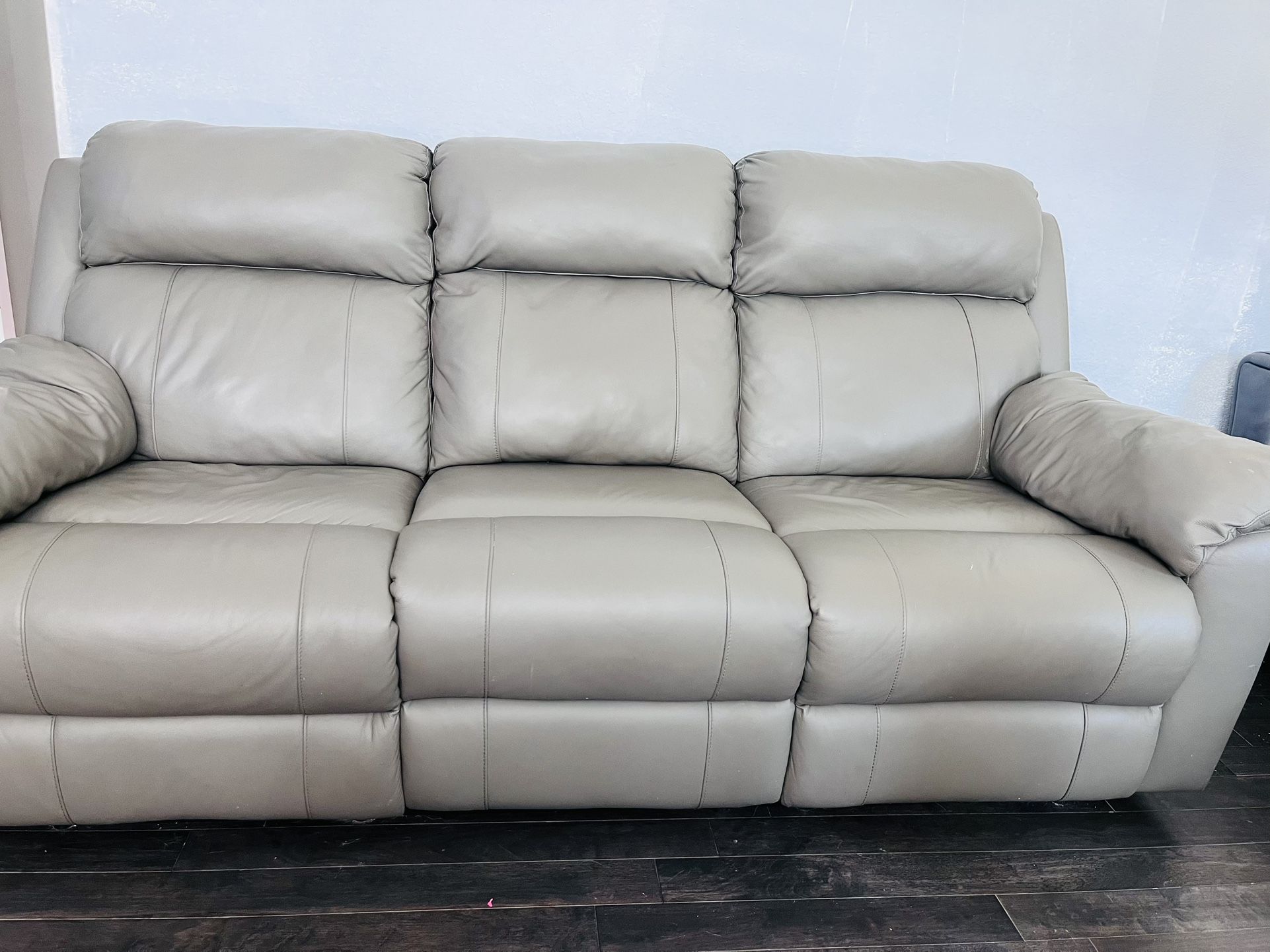 Matching gray top grain leather reclining sofa and recliner set