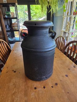 Vintage black metal milk can