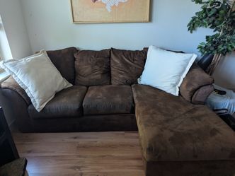 Brown couch with chaise and pillows