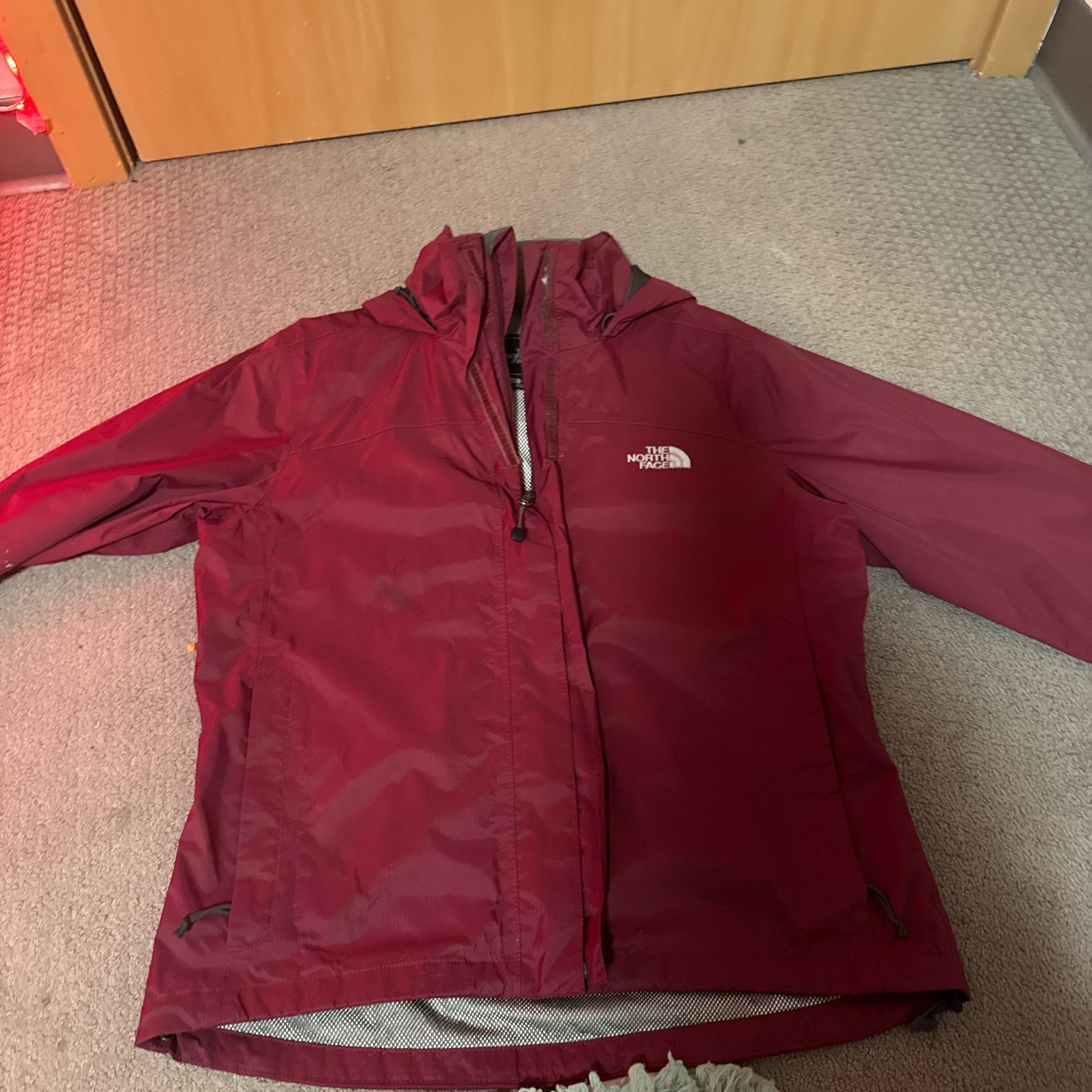 Small burgundy North Face rain coat