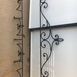 Black wrought iron wall decor to hang various items