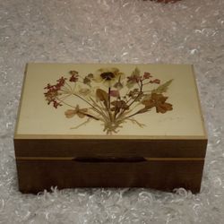 Vintage Reuge Swiss trinket music box with pressed flowers on the lid.