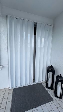 Accordion hurricane shutters
