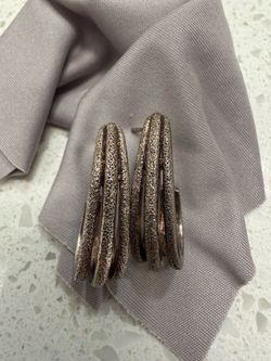 Multi-orbit silver hoop earrings feature a unique triple-band design