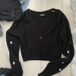black cardigan with little flower pattern on the arms