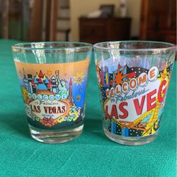 Las Vegas pair of collectible clear glass shot glasses printed Vegas casinos everywhere