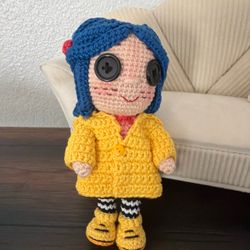 Handmade crochet Coraline with button eyes and fully removable rain coat