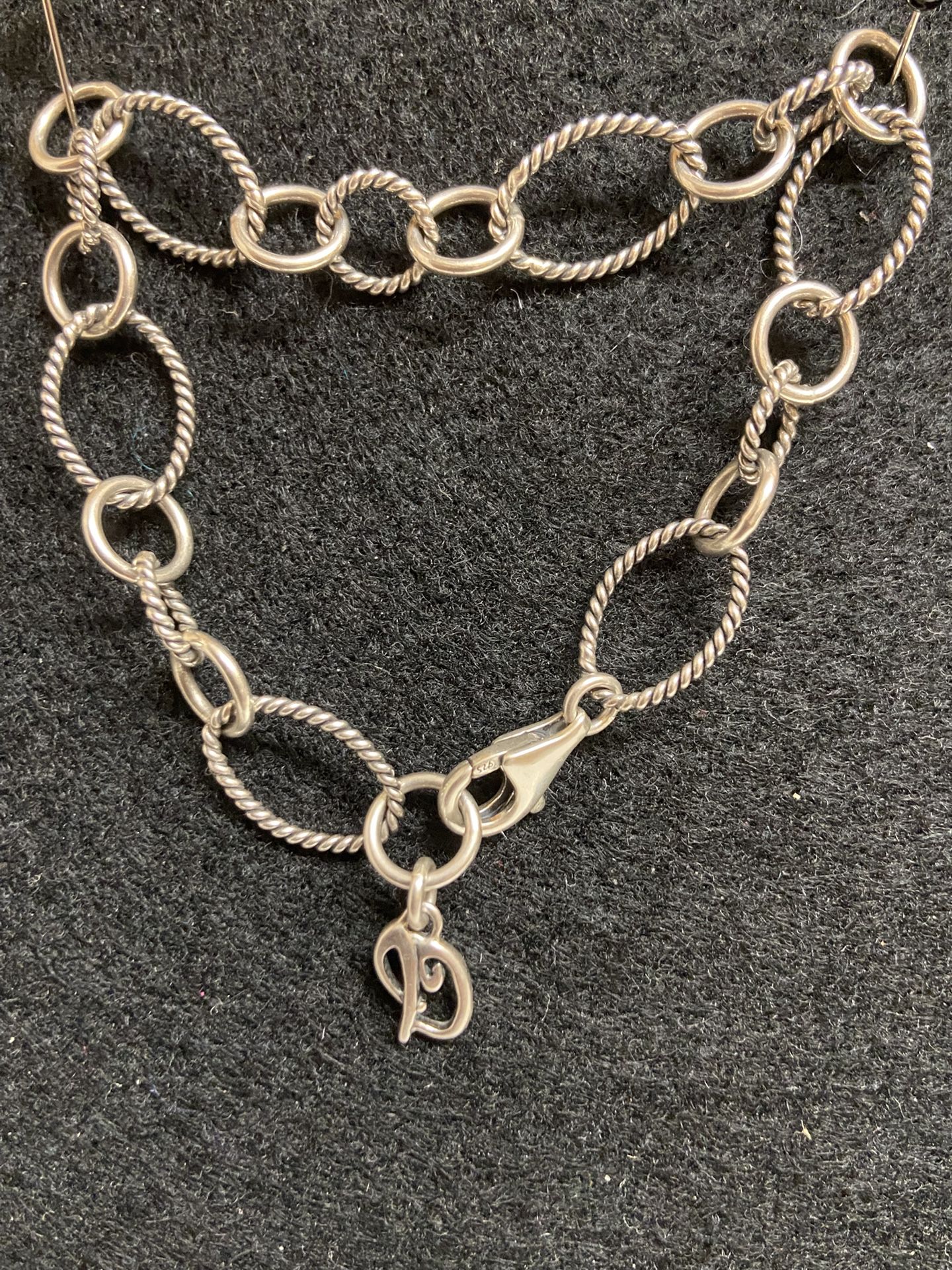  The Carolyn Pollack Silver Cable Link Charm Bracelet is a vintage piece of jewelry made of 925 sterling silver. It features a charm style design with