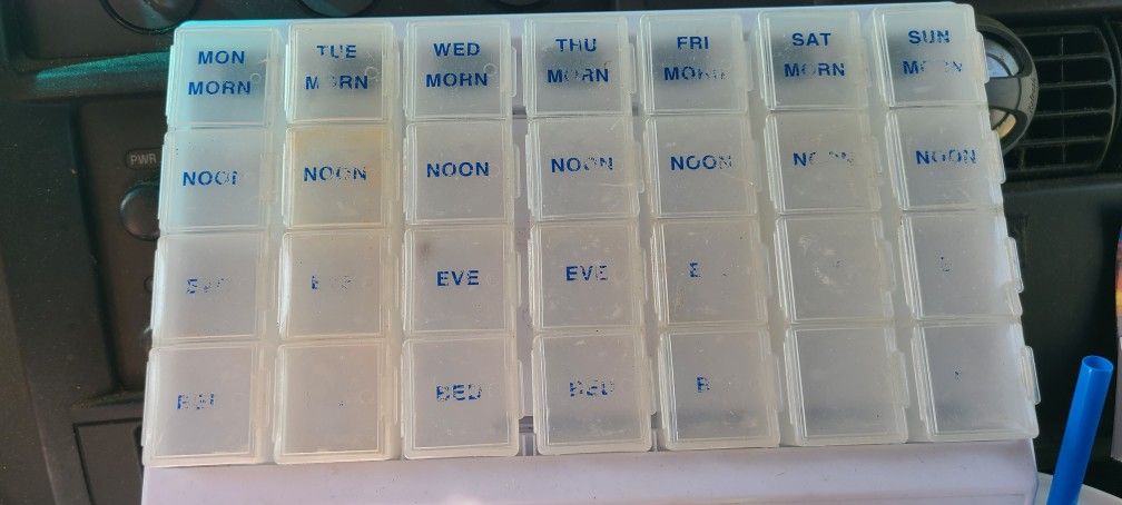 4 Times a day x 7 days a week pill organizer case. Squares approx 1" ea. Each day removable. Faded. East, west, north