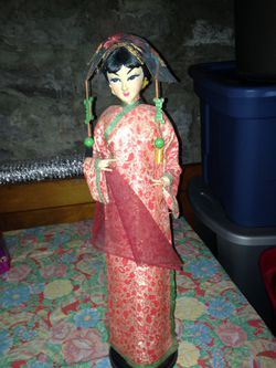 Vintage oriental doll on stand