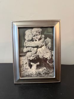 Cherubs in a brushed nickel toned silver frame
