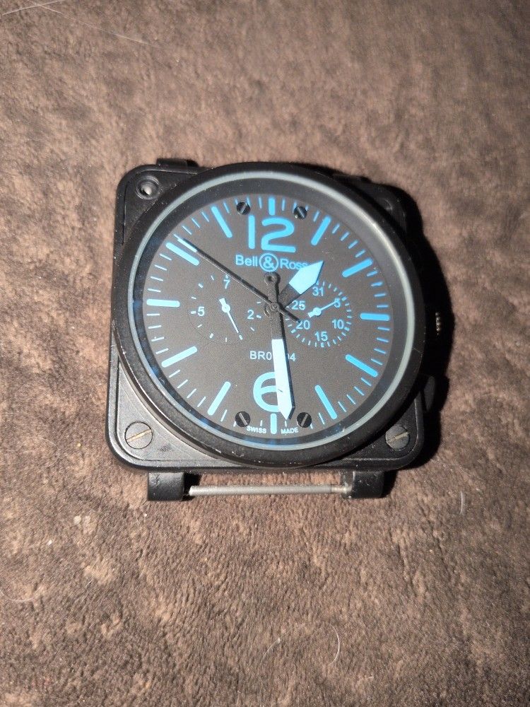 Bell & Ross Chronograph watch w/ a black carbon coated steel case black dial & blue luminous indices & hands.