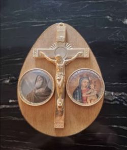 teardrop-shaped wooden plaque you just showed. It is a traditional Italian Catholic wall art