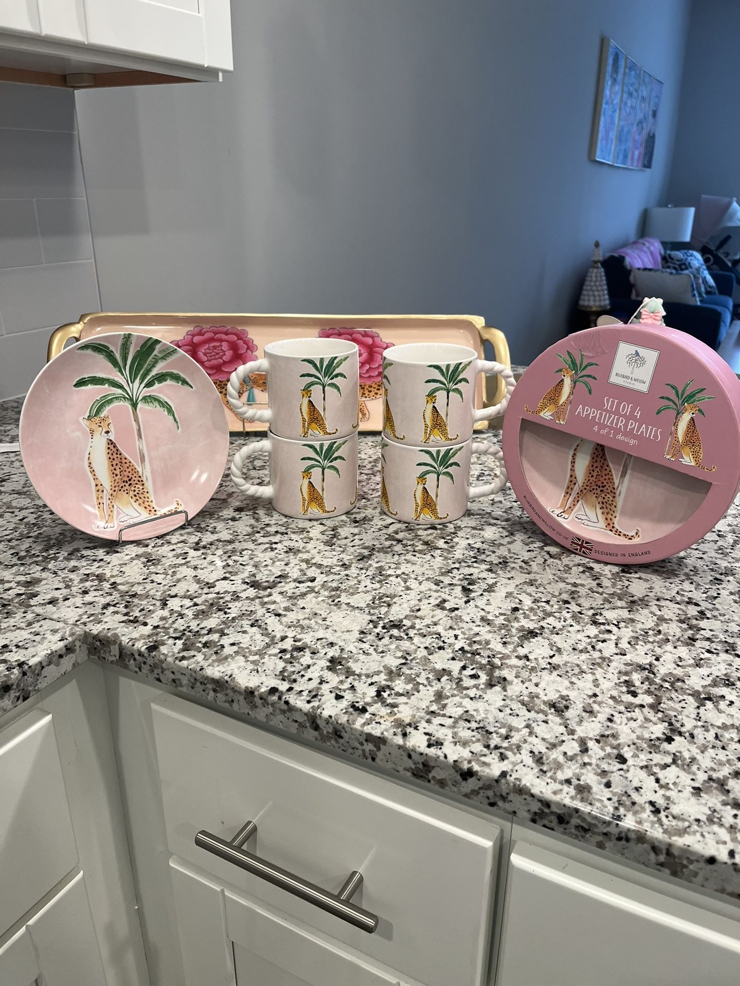A set of four mugs and four the print is a cheetah and background with a palm trees Appetizer Plates And Four Mugs