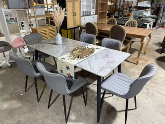 Brand new Brand new Modern dining set includes a rectangular table with a grey marble-patterned top and black metal legs. Six armless dining chairs   