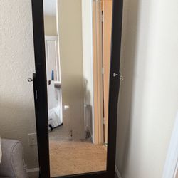 Jewelry armoire cabinet and full length mirror with velvet storage