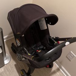 Black Doona Infant Car Seat/Stroller And Base for Car