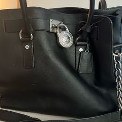 Used 100% Leather Black Michael Kors Bag With Silver Accents.